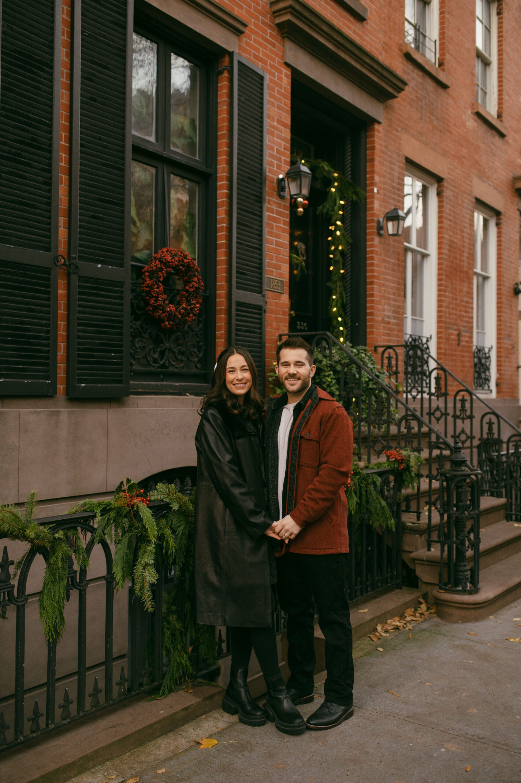 A couple in front of a brownstone