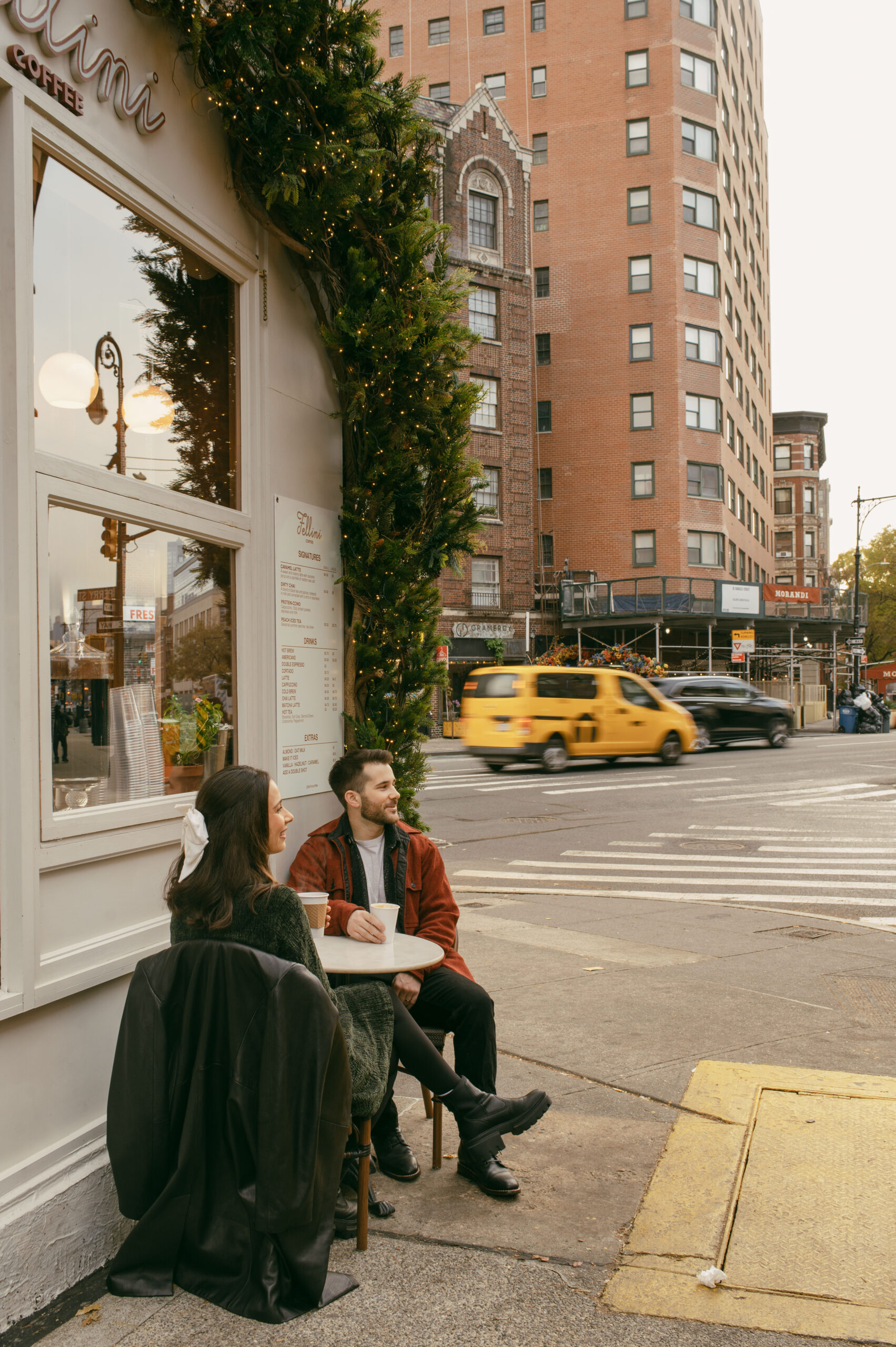 A couple has coffee at Fellini Coffee in West Village in New York City during their couples session photoshoot