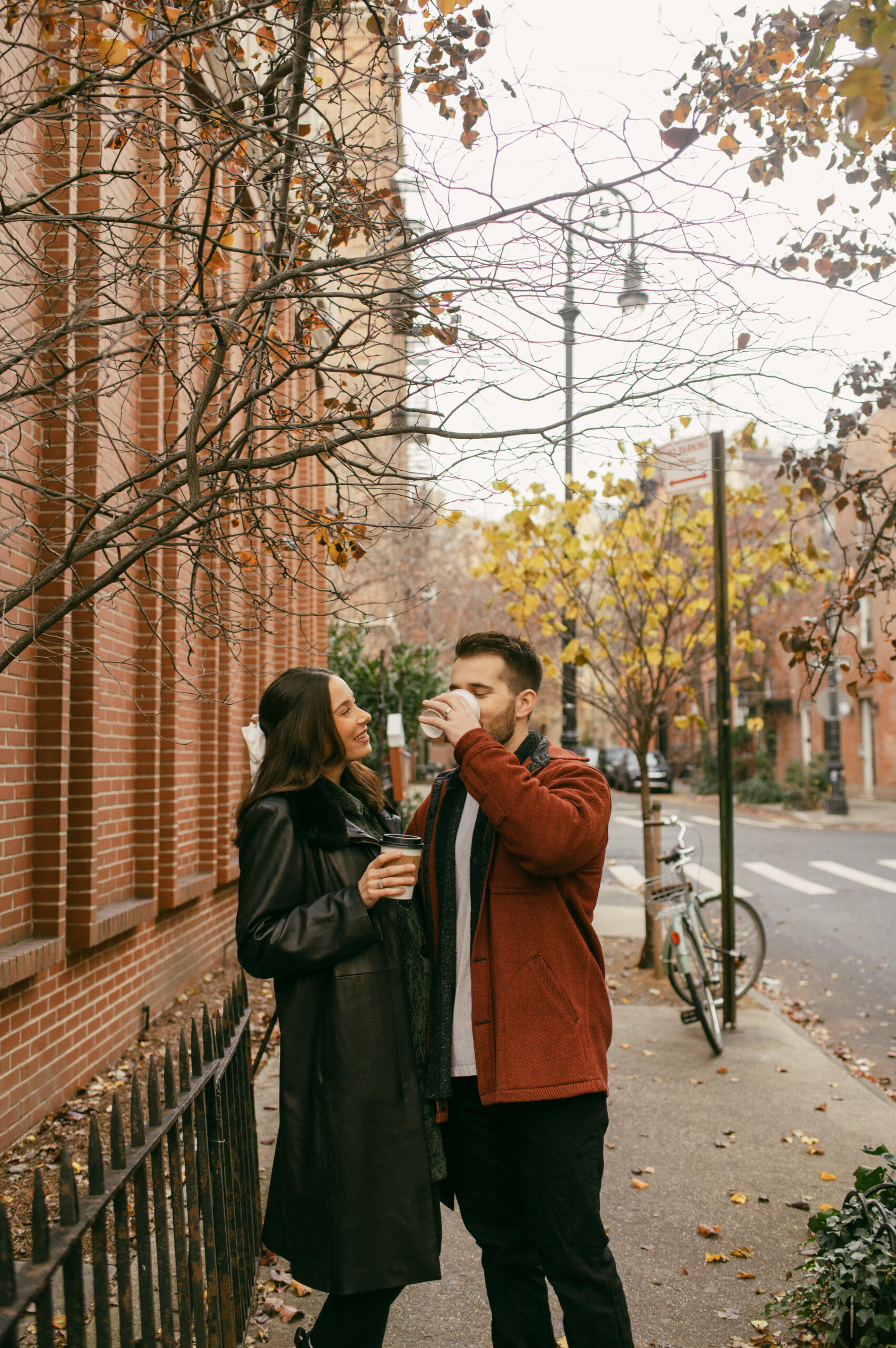 A couple walks around West Village in New York City with their Fellini Coffee cups during a photoshoot in the winter.