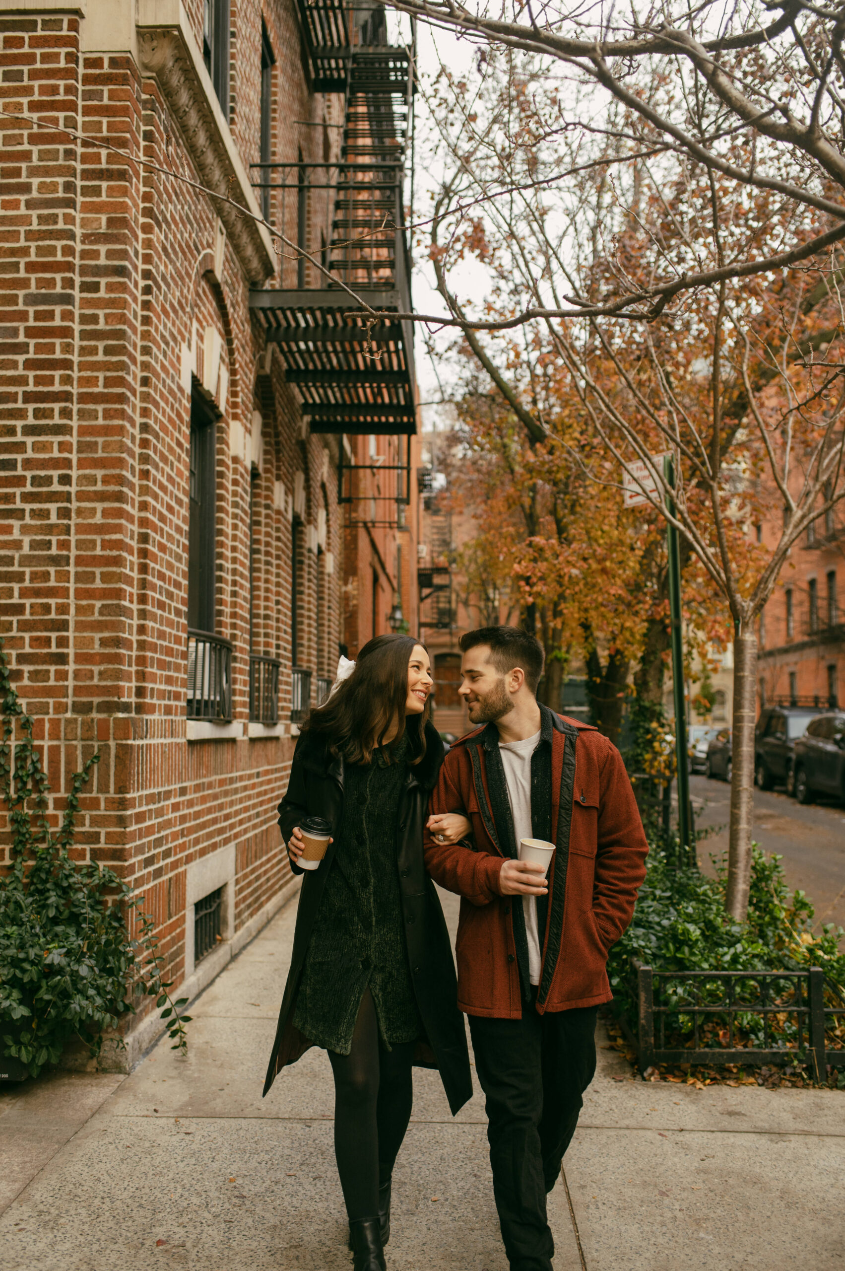 A couple walks around West Village in New York City with their Fellini Coffee cups during a photoshoot in the winter.