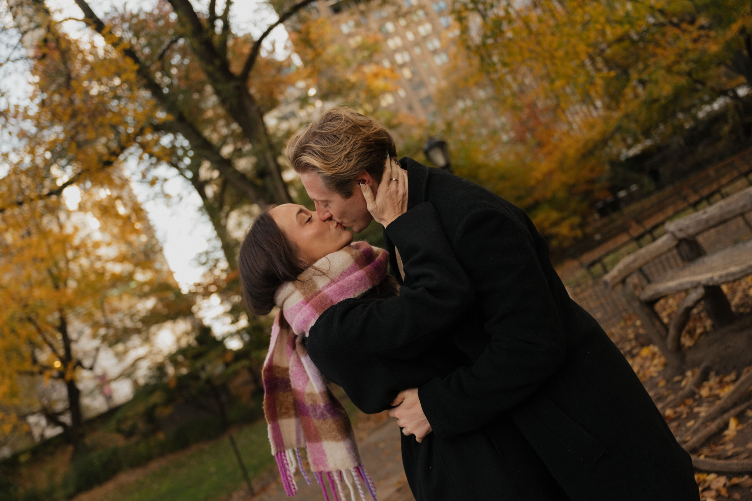 A couple kissing in Central Park during the Fall weather and colors | New York City Wedding PHotographer