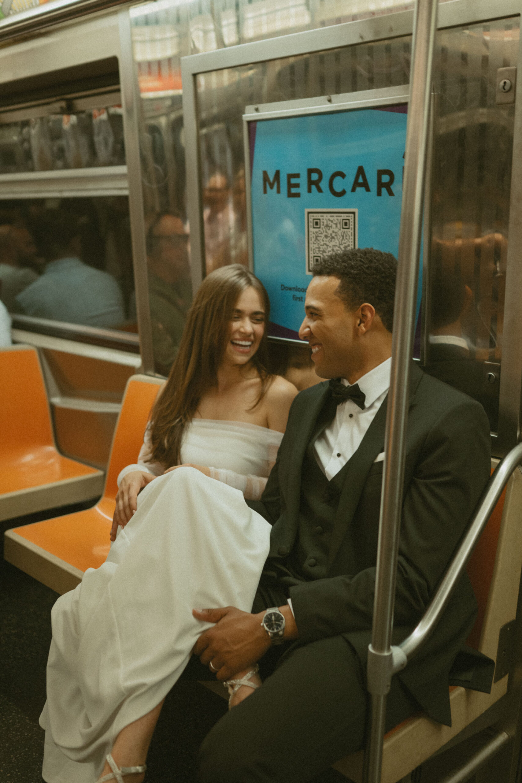 Newlyweds riding the NYC subway after getting married at City Hall.